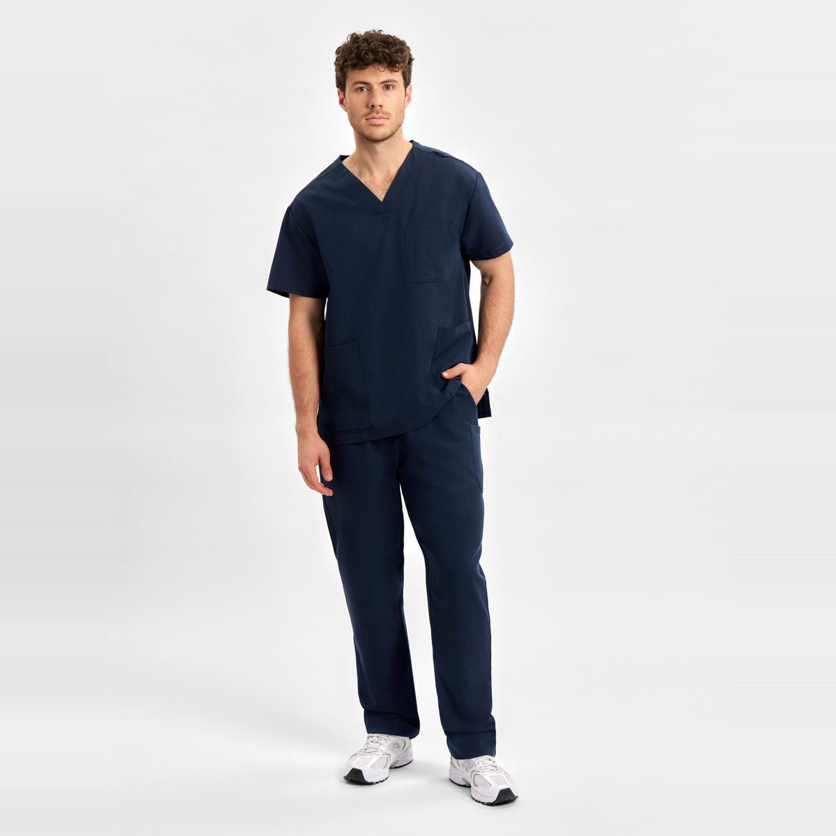 Inaura Pulse Unisex Straight Leg Scrub Pant CL542UL in Midnight Navy, worn by model