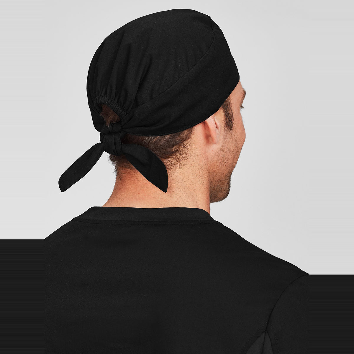 Inaura Reversible Unisex Scrub Cap CSC249U in Black, worn by model, view 3
