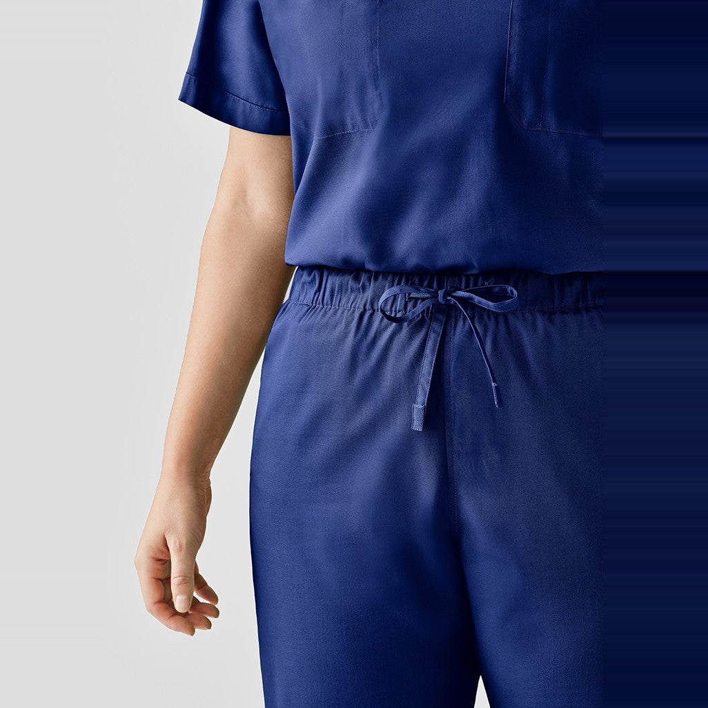 Inaura Hartwell Unisex Reversible Scrub Pant CSP151UL in Dark Blue, worn by model, view 2