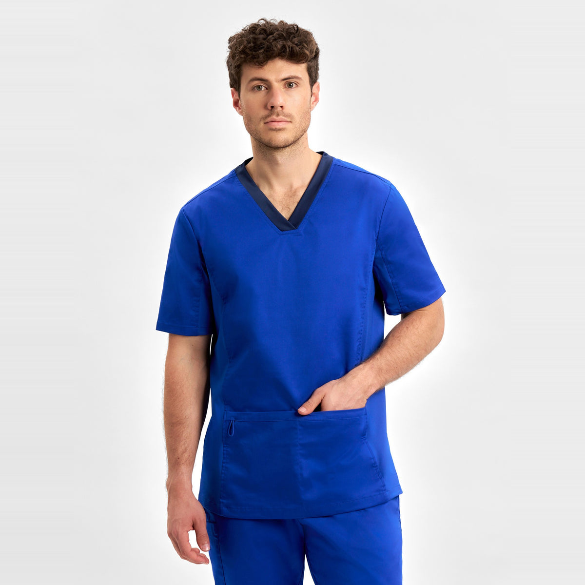 Inaura Riley Mens Stretch Scrub Top CST043MS in Electric Blue, worn by model