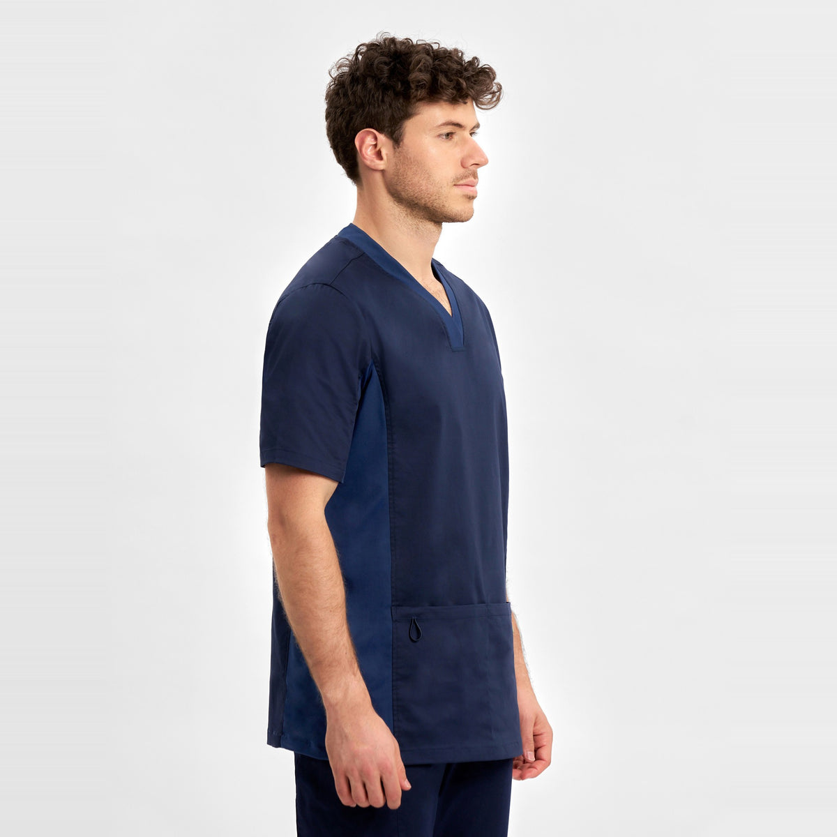 Inaura Riley Mens Stretch Scrub Top CST043MS in Midnight Navy, worn by model, view 3