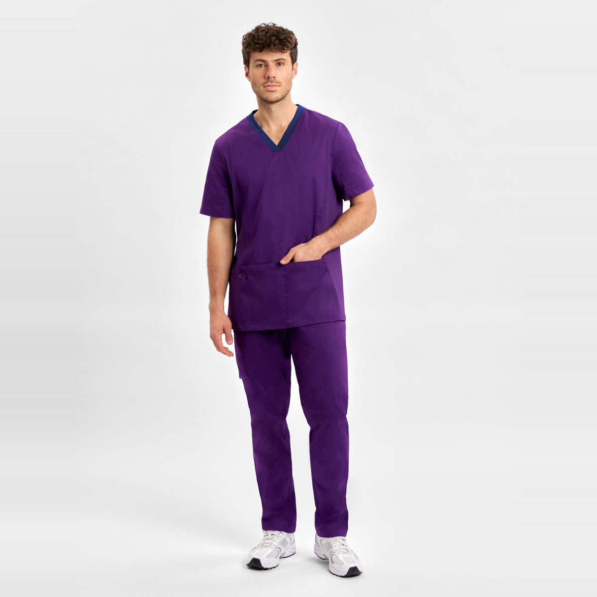 Inaura Riley Mens Stretch Scrub Top CST043MS in Purple, worn by model, view 2