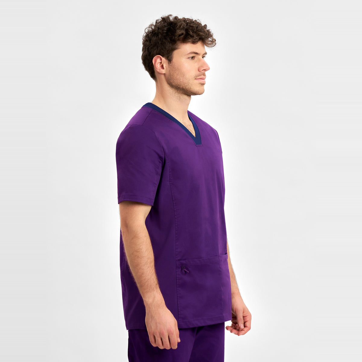 Inaura Riley Mens Stretch Scrub Top CST043MS in Purple, worn by model, view 3