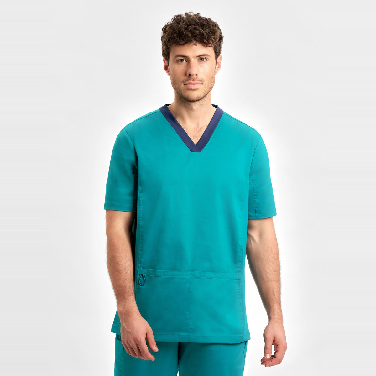 Inaura Riley Mens Stretch Scrub Top CST043MS in Teal, worn by model
