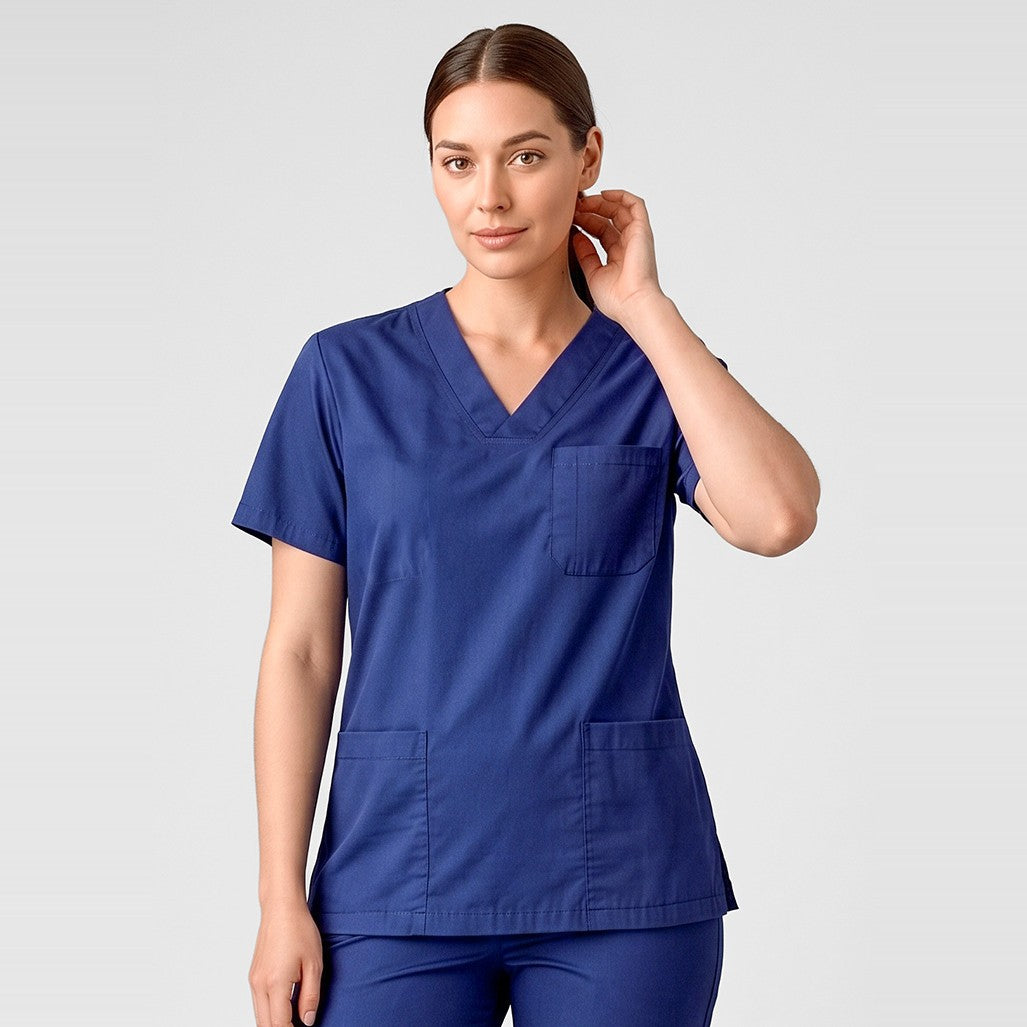 Inaura Hartwell Unisex Reversible Scrub Top CST150US in Dark Blue, worn by model