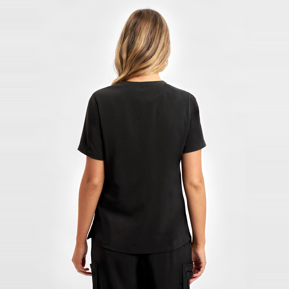 Inaura Avery Womens V-Neck Scrub Top CST941LS in Black, worn by model, view 4