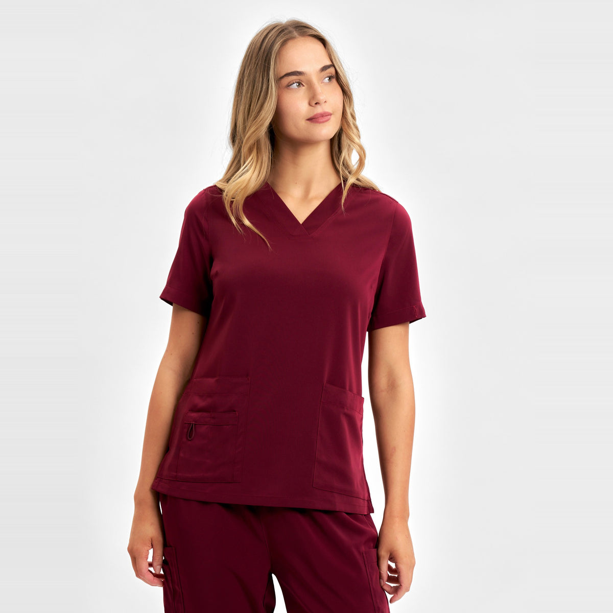 Inaura Avery Womens V-Neck Scrub Top CST941LS in Burgundy, worn by model