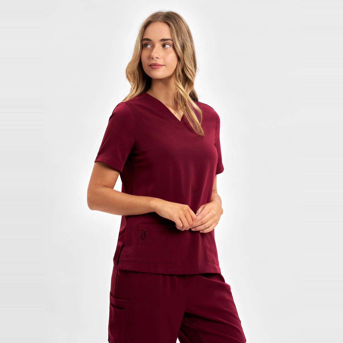 Inaura Avery Womens V-Neck Scrub Top CST941LS in Burgundy, worn by model, view 3