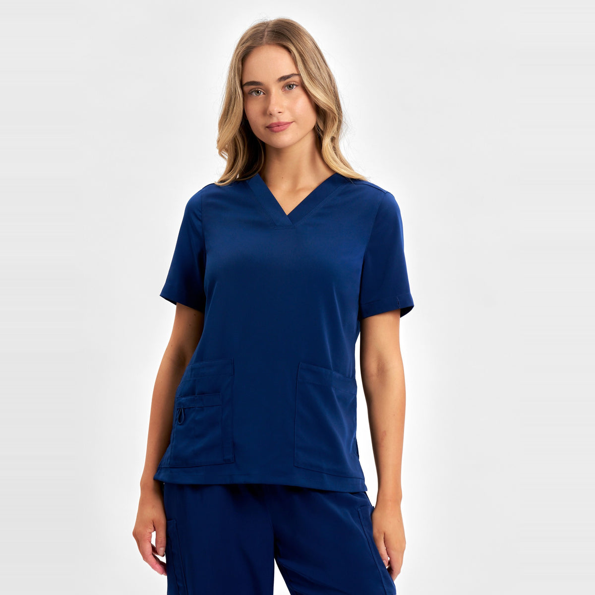 Inaura Avery Womens V-Neck Scrub Top CST941LS in Navy, worn by model