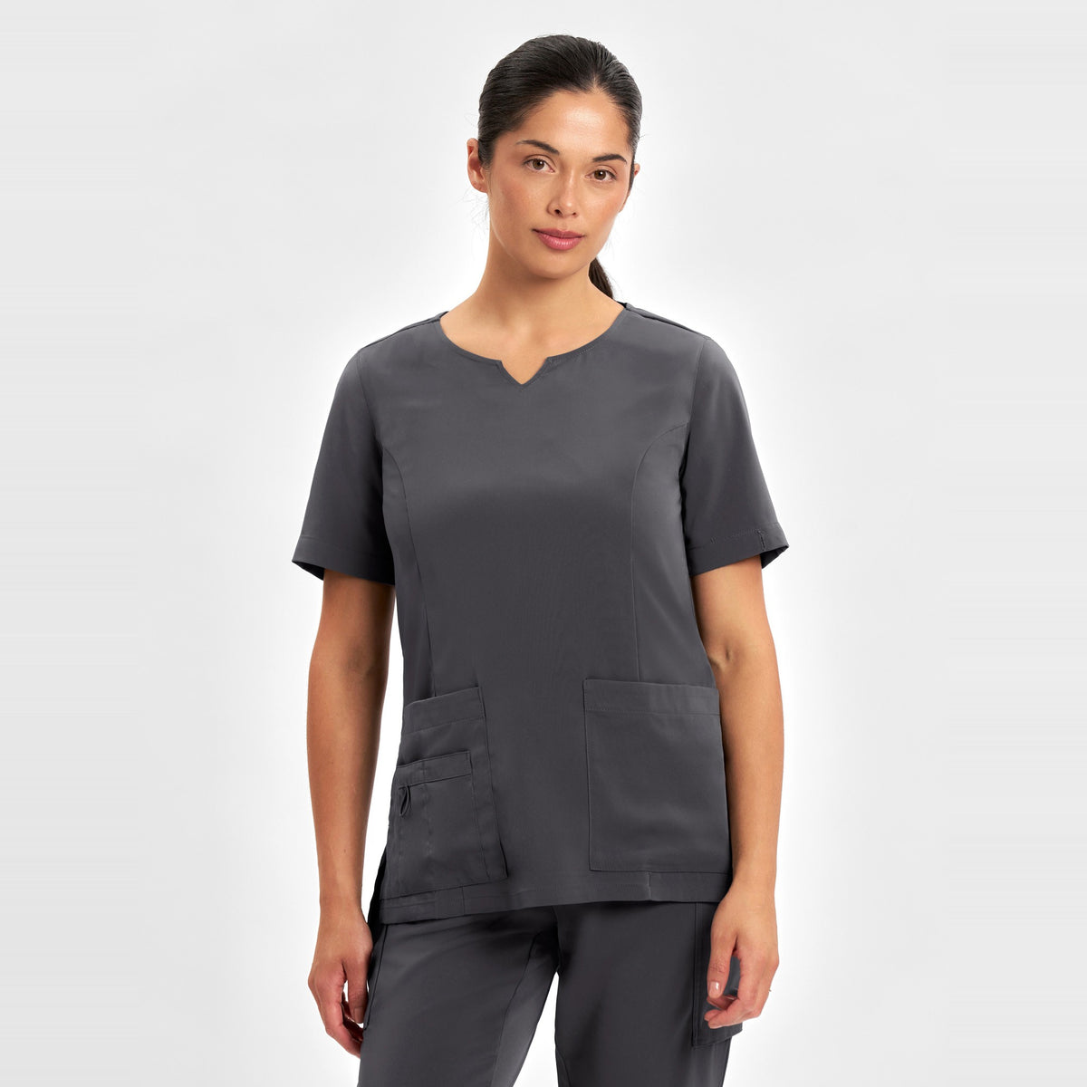 Inaura Avery Womens Round Neck Scrub Top CST942LS in Charcoal, worn by model