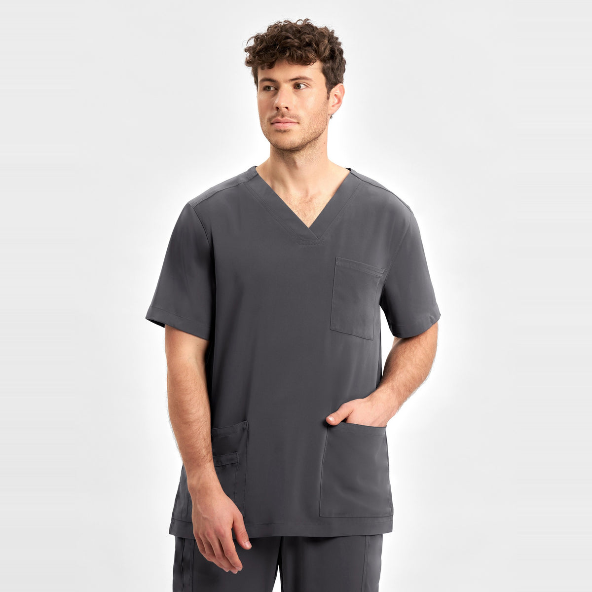 Inaura Avery Mens V-Neck Scrub Top CST945MS in Charcoal, worn by model