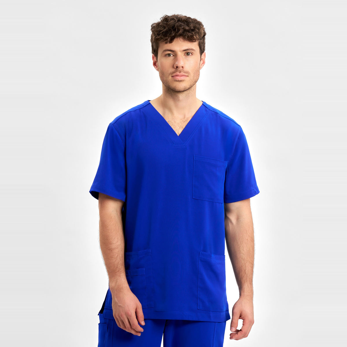 Inaura Avery Mens V-Neck Scrub Top CST945MS in Electric Blue, worn by model