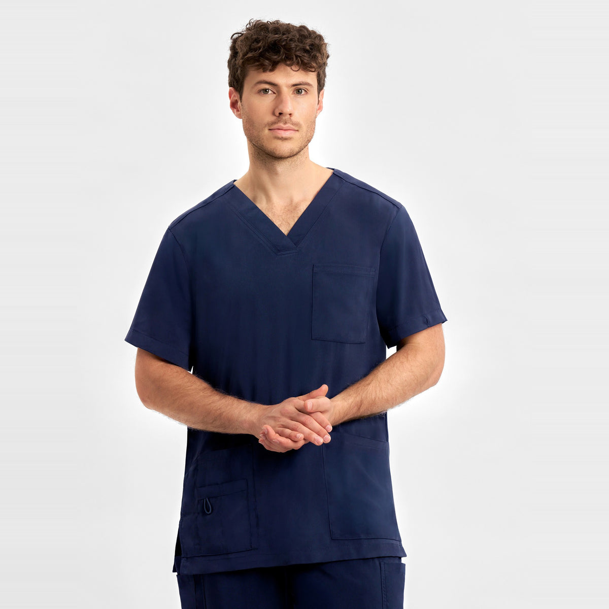 Inaura Avery Mens V-Neck Scrub Top CST945MS in Midnight Navy, worn by model