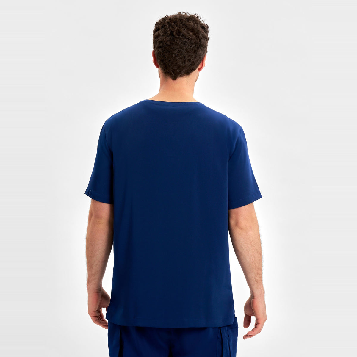 Inaura Avery Mens V-Neck Scrub Top CST945MS in Navy, worn by model, view 4