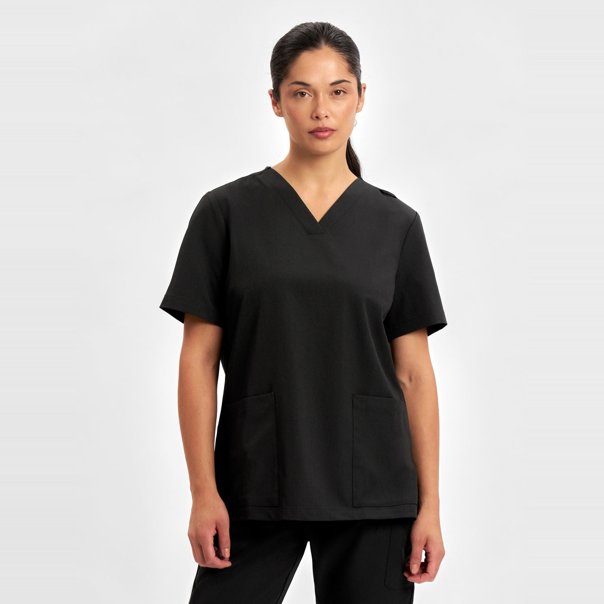 Inaura Pulse Womens V-Neck Scrub Top CU543LS in Black, worn by model