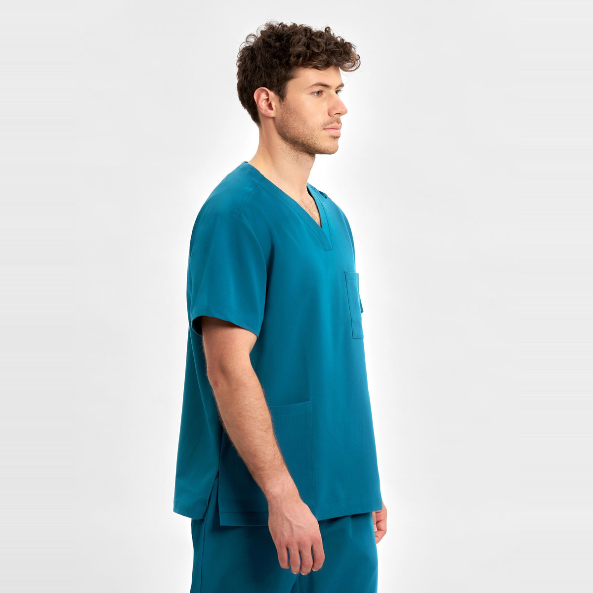 Inaura Pulse Unisex V-Neck Scrub Top CU544US in Caribbean Blue, worn by model, view 4