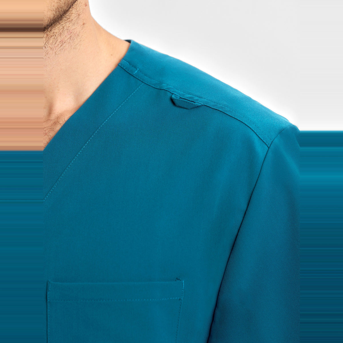 Inaura Pulse Unisex V-Neck Scrub Top CU544US in Caribbean Blue, worn by model, view 7