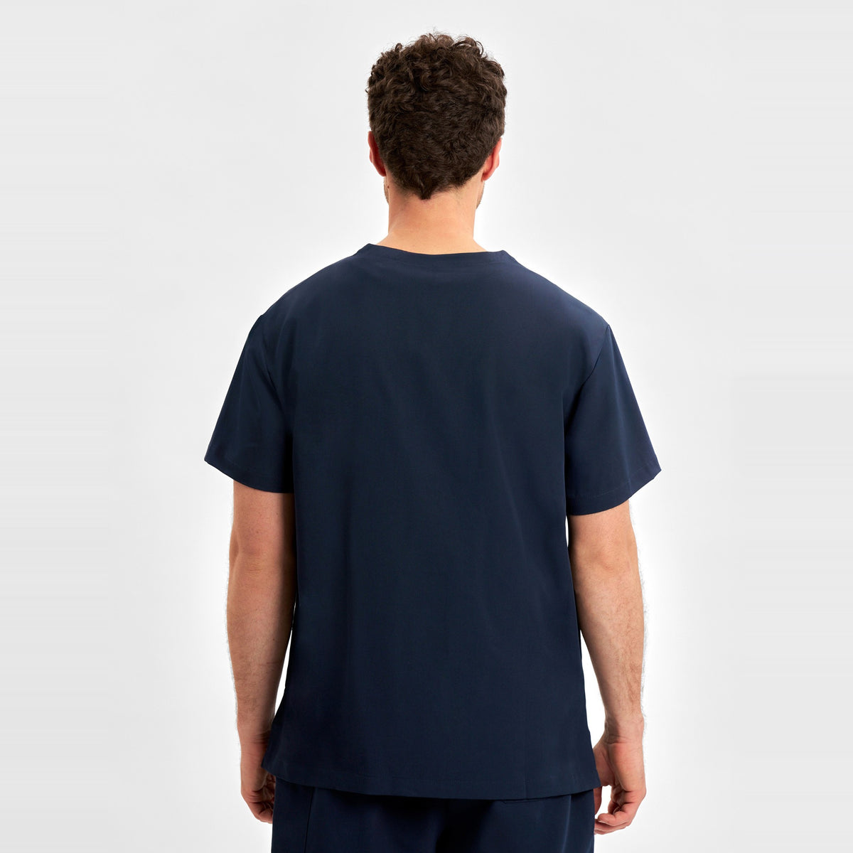 Inaura Pulse Unisex V-Neck Scrub Top CU544US in Midnight Navy, worn by model, view 4