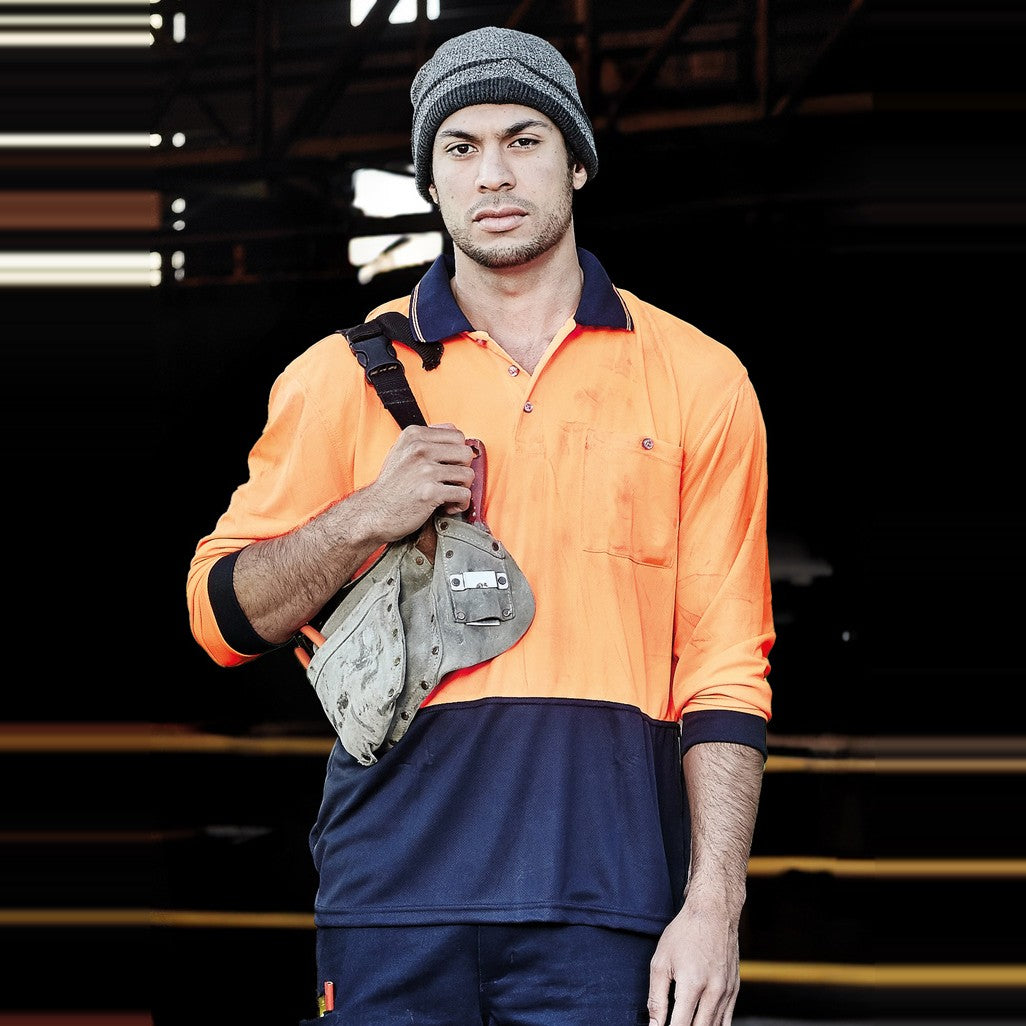 Syzmik Unisex Hi Vis Basic Long Sleeve Polo ZH232 in Orange/Navy, worn by model