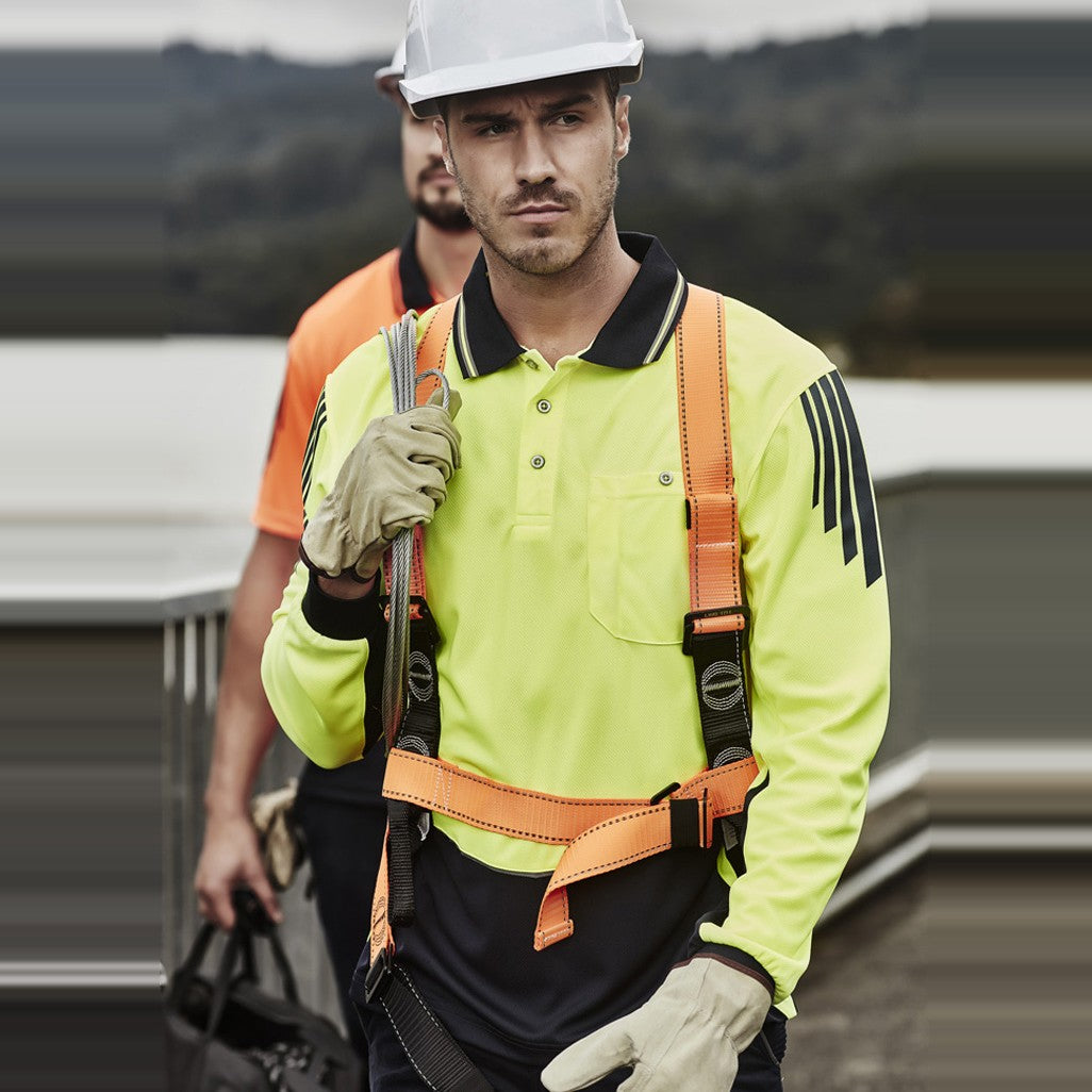 Syzmik Mens Hi Vis Flux Long Sleeve Polo ZH310 in Yellow/Navy, worn by model