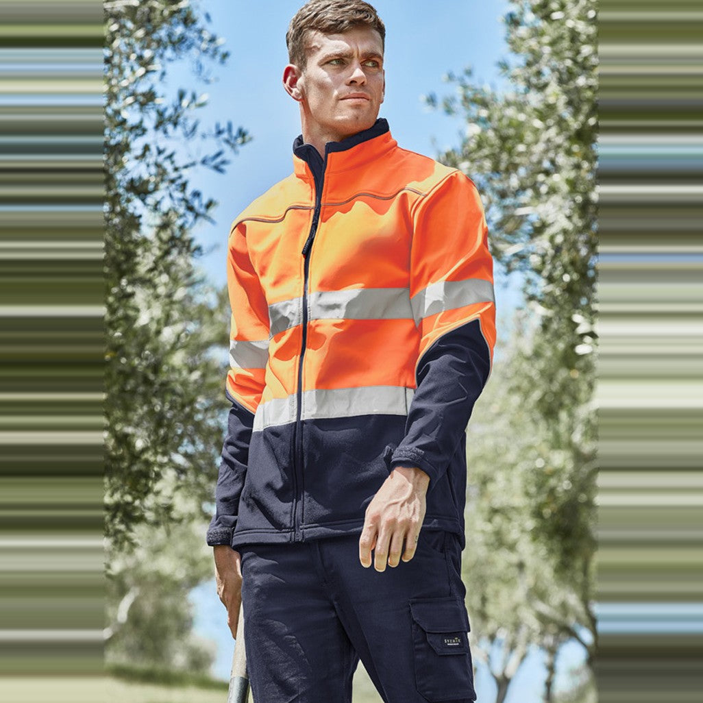 Syzmik Unisex Hi Vis Softshell Jacket ZJ353 in Orange/Navy, worn by model