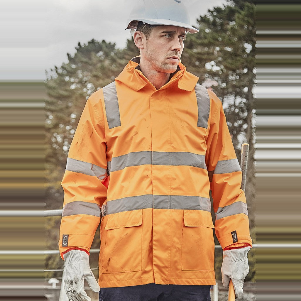 Syzmik Unisex Hi Vis VIC Rail 4 In 1 Waterproof Jacket ZJ580 in VIC Rail Orange, worn by model