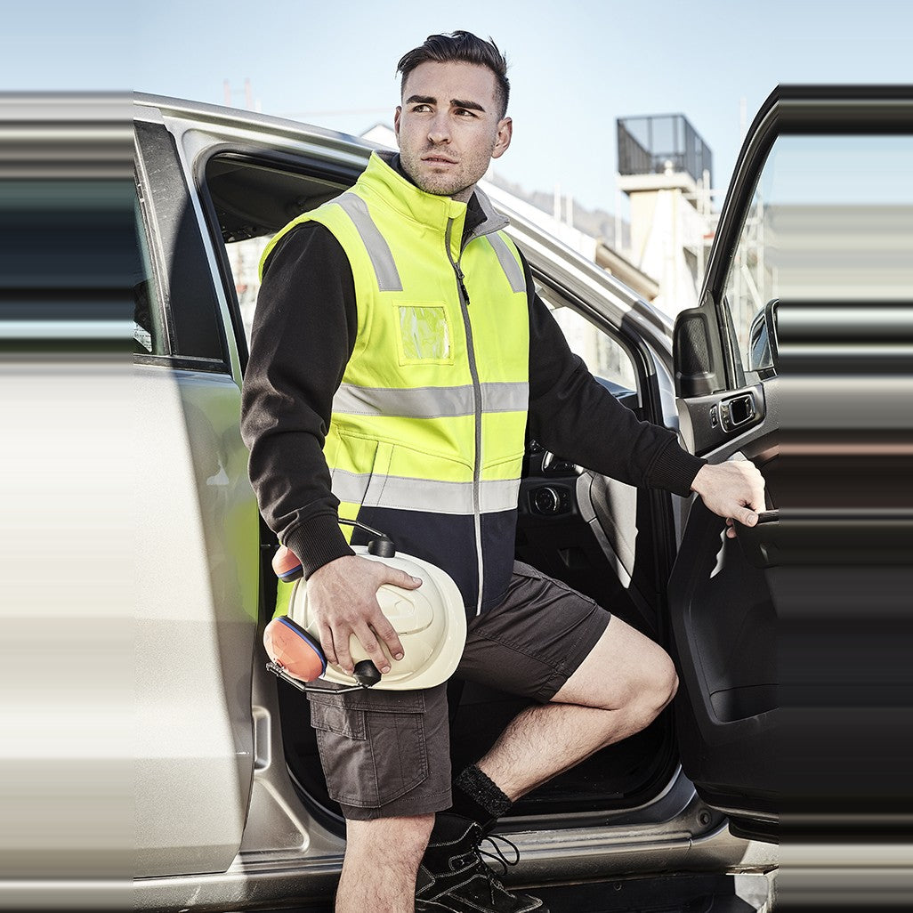 Syzmik Unisex Hi Vis Softshell Vest ZV426, worn by model