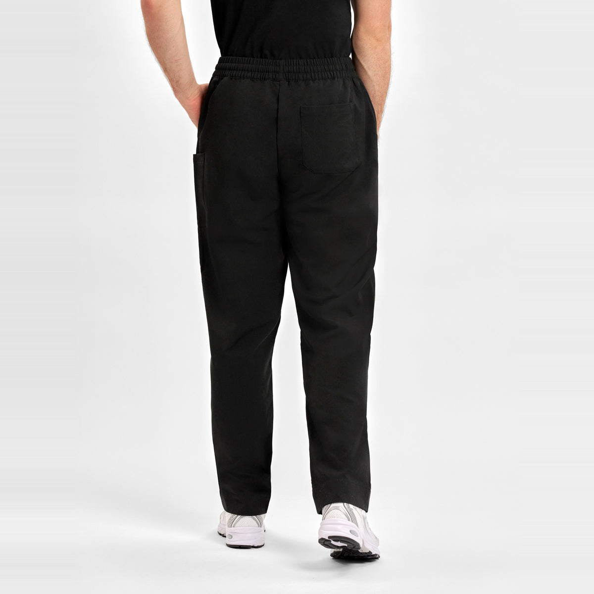 Inaura Pulse Unisex Straight Leg Scrub Pant CL542UL in Black, worn by model, view 4
