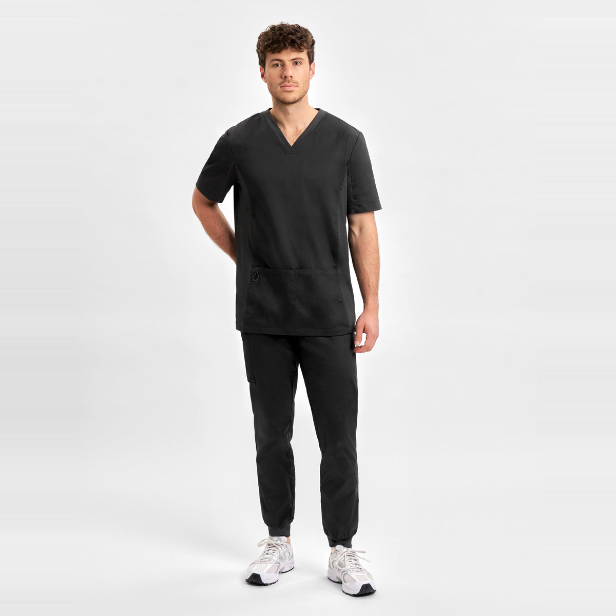 Inaura Riley Mens Slim Leg Jogger Scrub Pant CSP042ML in Black, worn by model