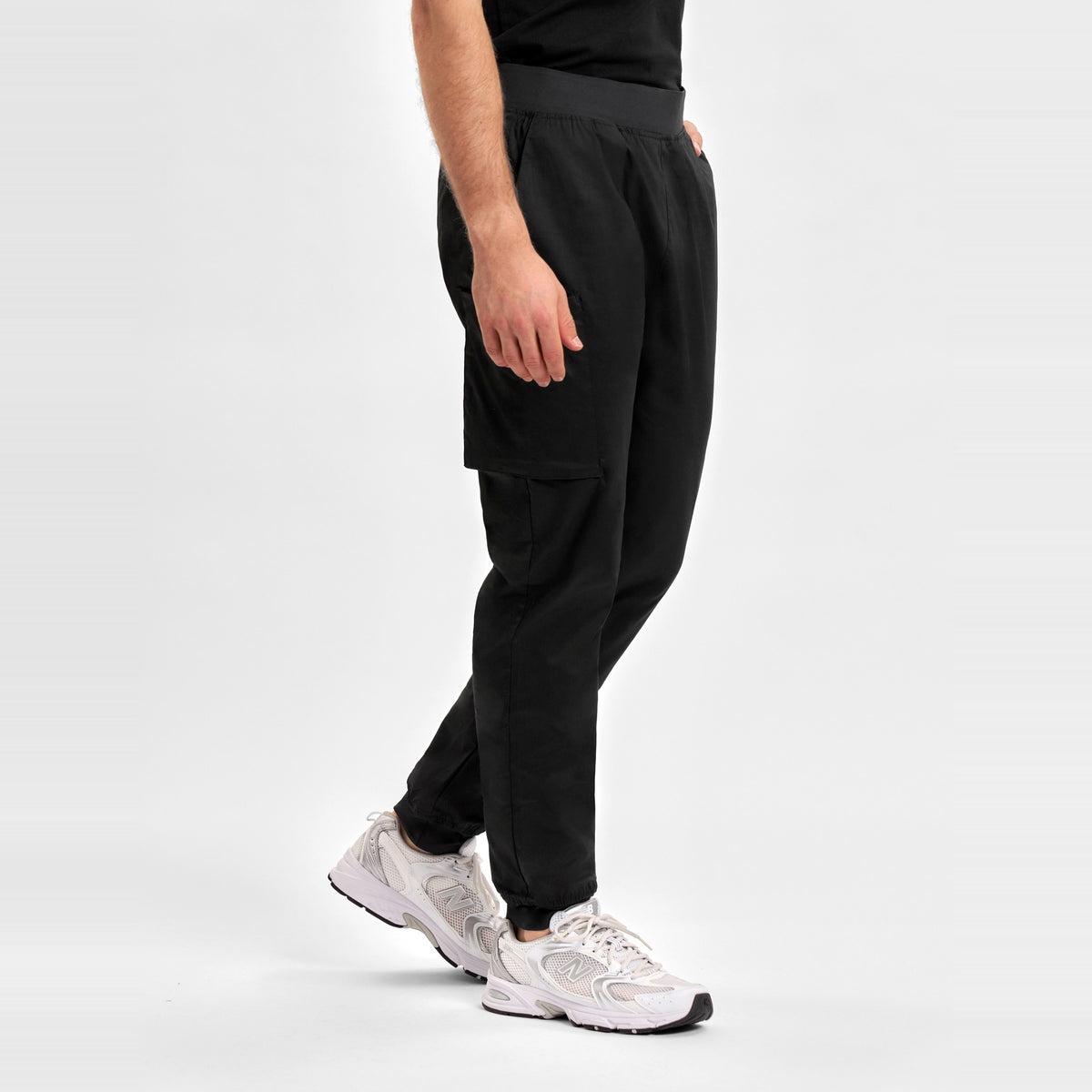 Inaura Riley Mens Slim Leg Jogger Scrub Pant CSP042ML in Black, worn by model, view 3