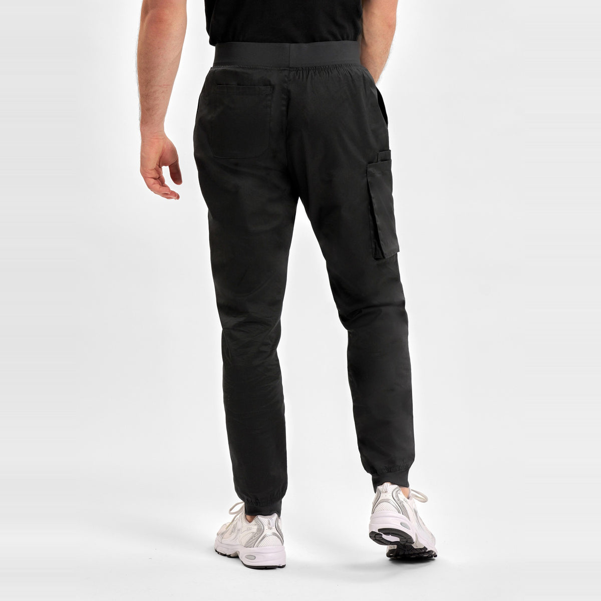 Inaura Riley Mens Slim Leg Jogger Scrub Pant CSP042ML in Black, worn by model, view 4