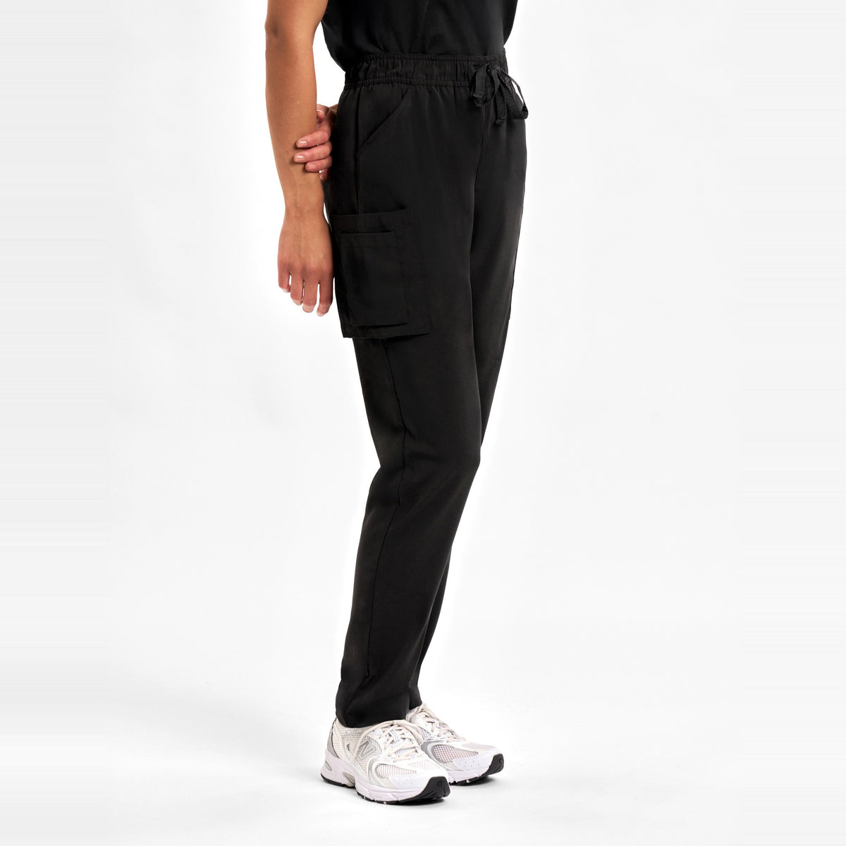 Inaura Avery Womens Slim Leg Scrub Pant CSP943LL in Black, worn by model, view 3