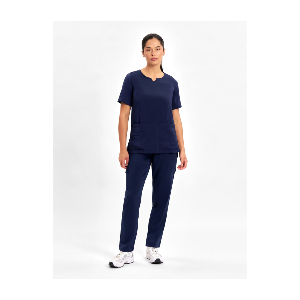 Inaura Avery Womens Slim Leg Scrub Pant CSP943LL in Midnight Navy, worn by model