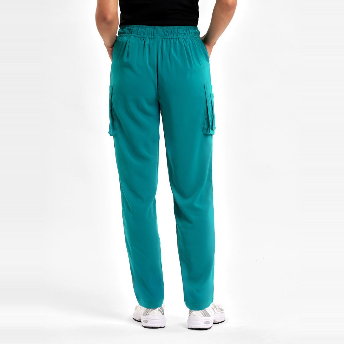 Inaura Avery Womens Slim Leg Scrub Pant CSP943LL in Teal, worn by model, view 4