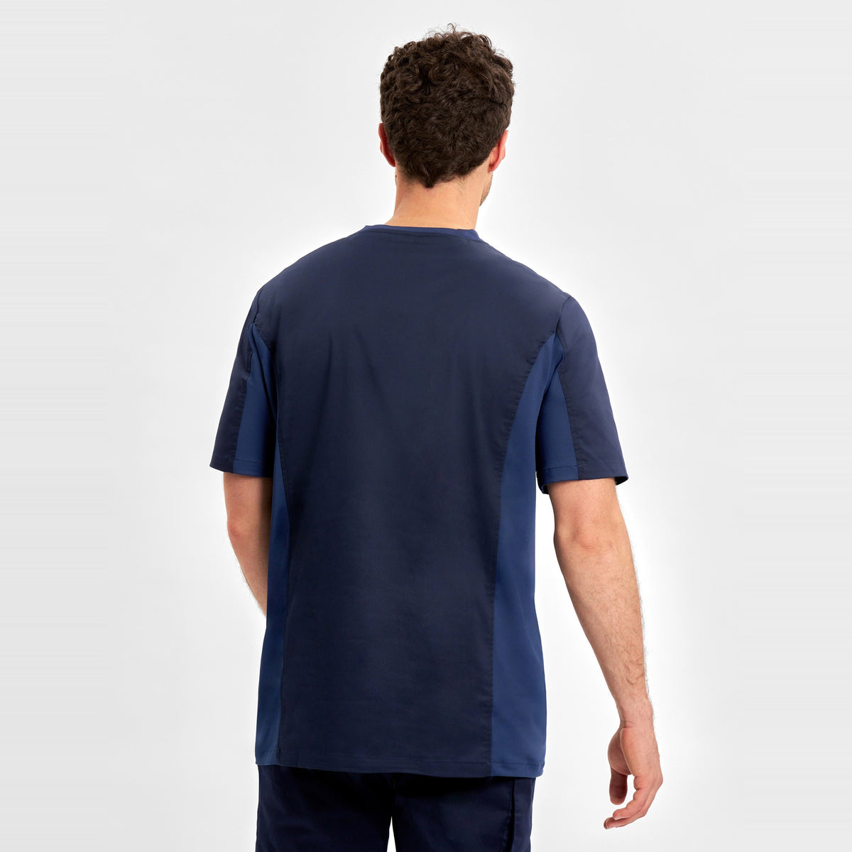 Inaura Riley Mens Stretch Scrub Top CST043MS in Midnight Navy, worn by model, view 4