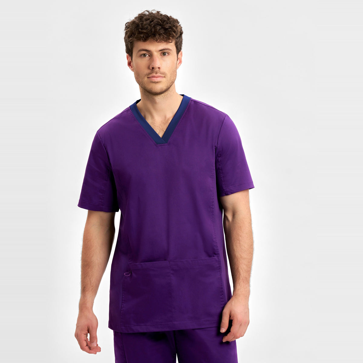 Inaura Riley Mens Stretch Scrub Top CST043MS in Purple, worn by model