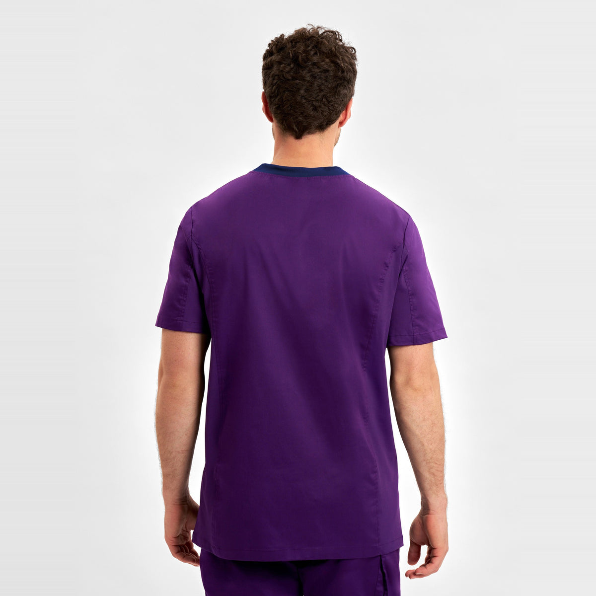Inaura Riley Mens Stretch Scrub Top CST043MS in Purple, worn by model, view 4