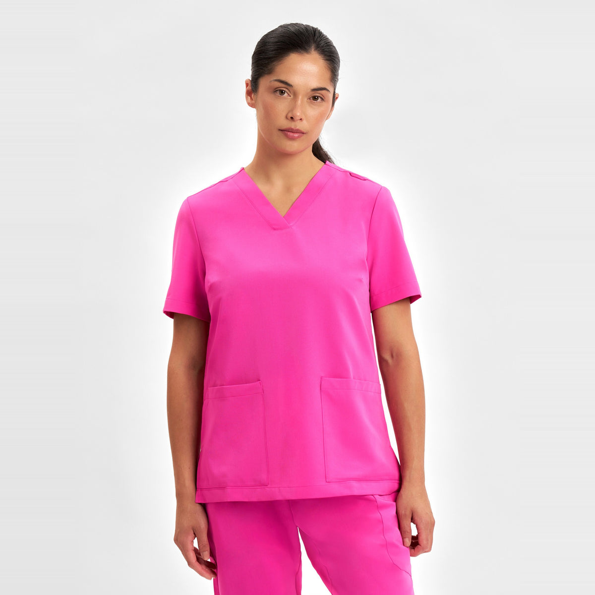 Inaura Pink Womens V-Neck Scrub Top CST245LS in Pink, worn by model