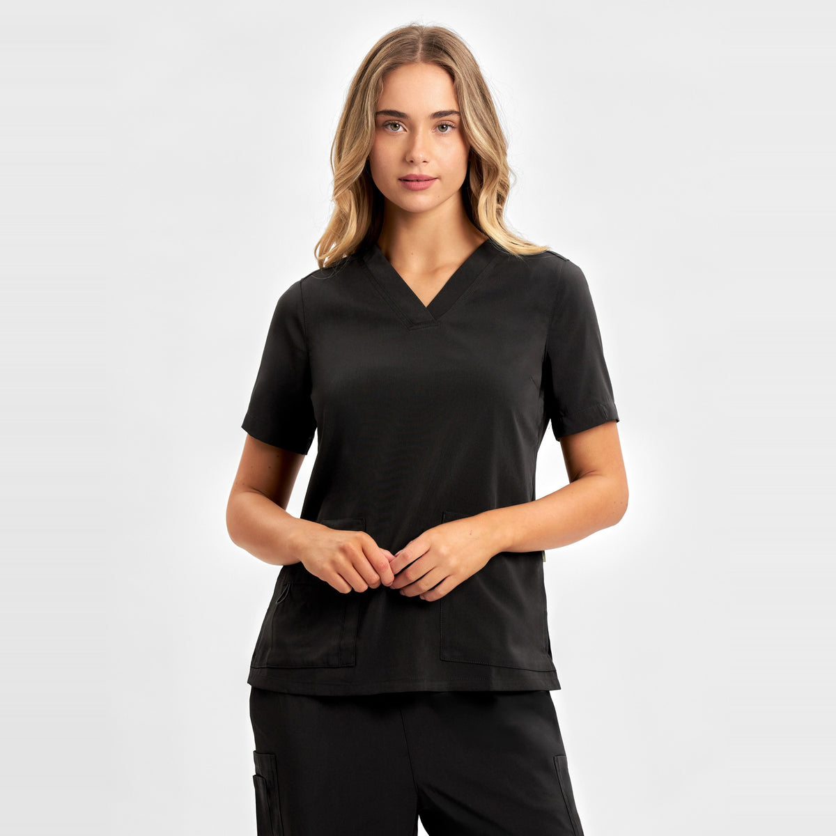 Inaura Avery Womens V-Neck Scrub Top CST941LS in Black, worn by model