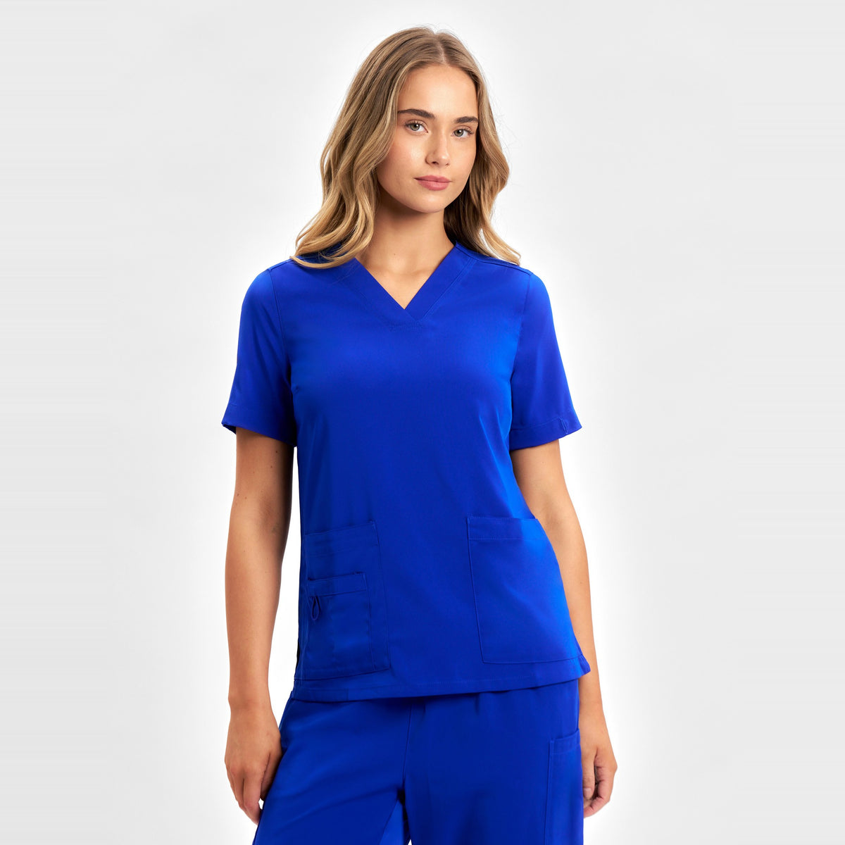 Inaura Avery Womens V-Neck Scrub Top CST941LS in Electric Blue, worn by model
