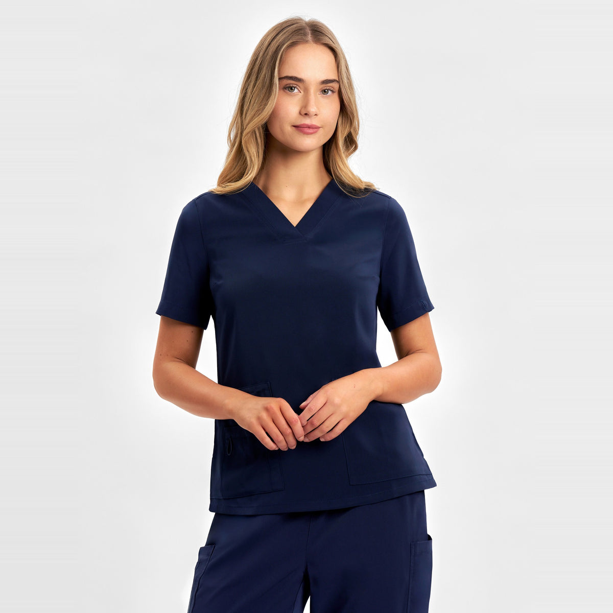 Inaura Avery Womens V-Neck Scrub Top CST941LS in Midnight Navy, worn by model