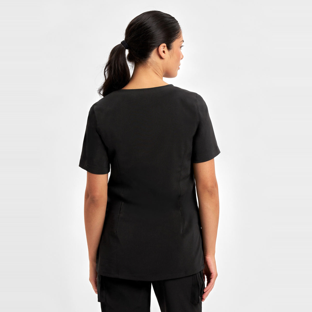 Inaura Avery Womens Round Neck Scrub Top CST942LS in Black, worn by model, view 4