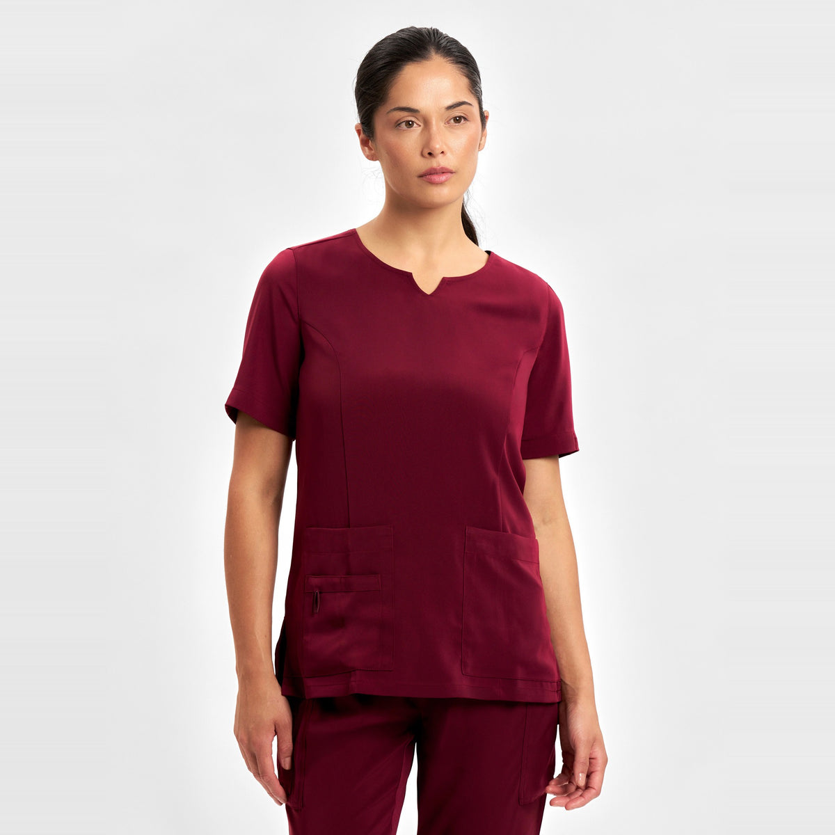 Inaura Avery Womens Round Neck Scrub Top CST942LS in Burgundy, worn by model
