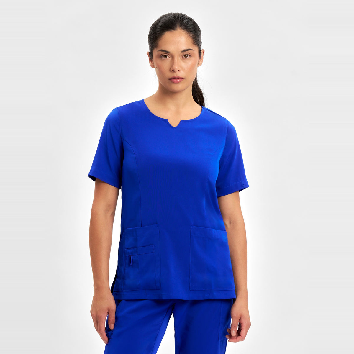 Inaura Avery Womens Round Neck Scrub Top CST942LS in Electric Blue, worn by model