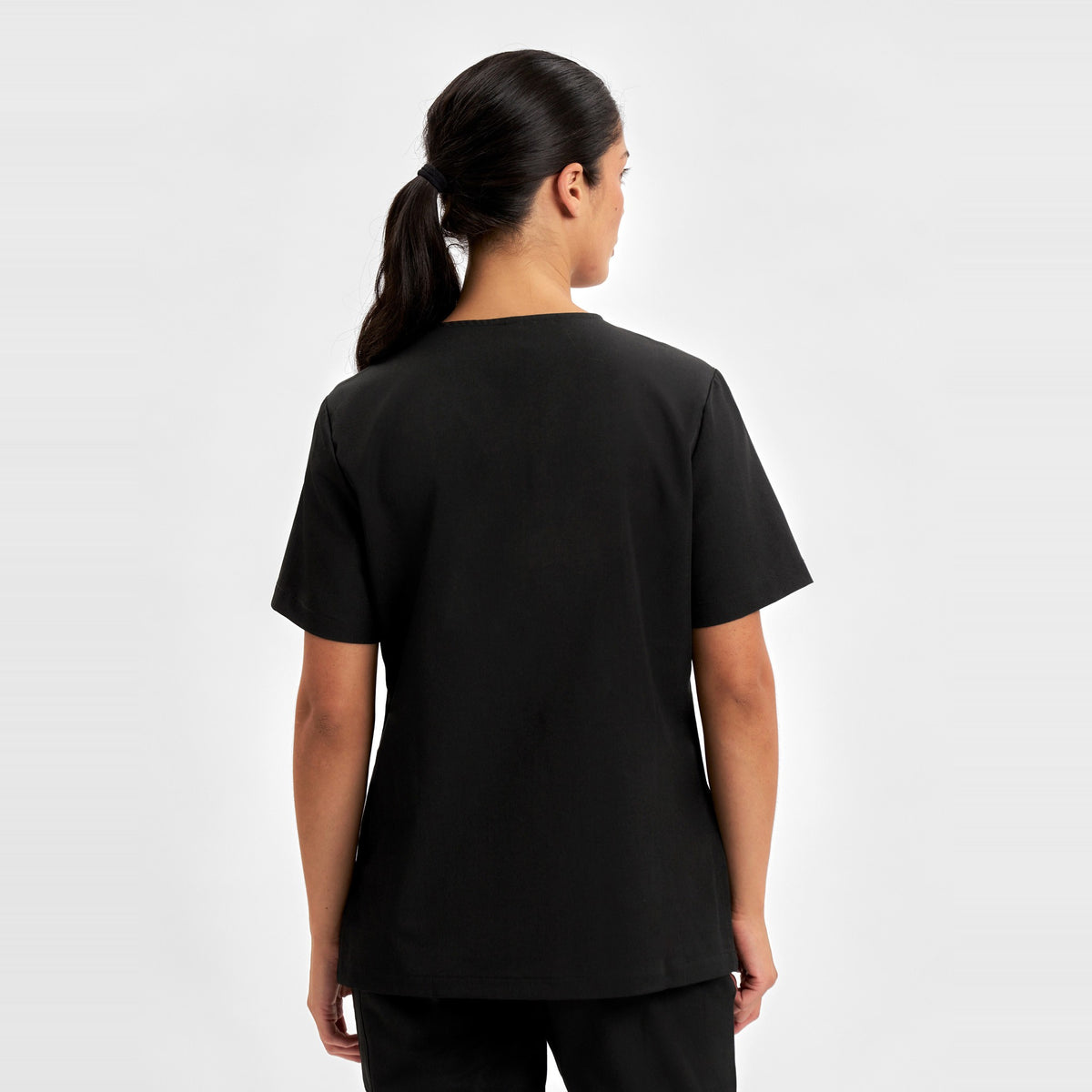 Inaura Pulse Womens V-Neck Scrub Top CU543LS in Black, worn by model, view 3
