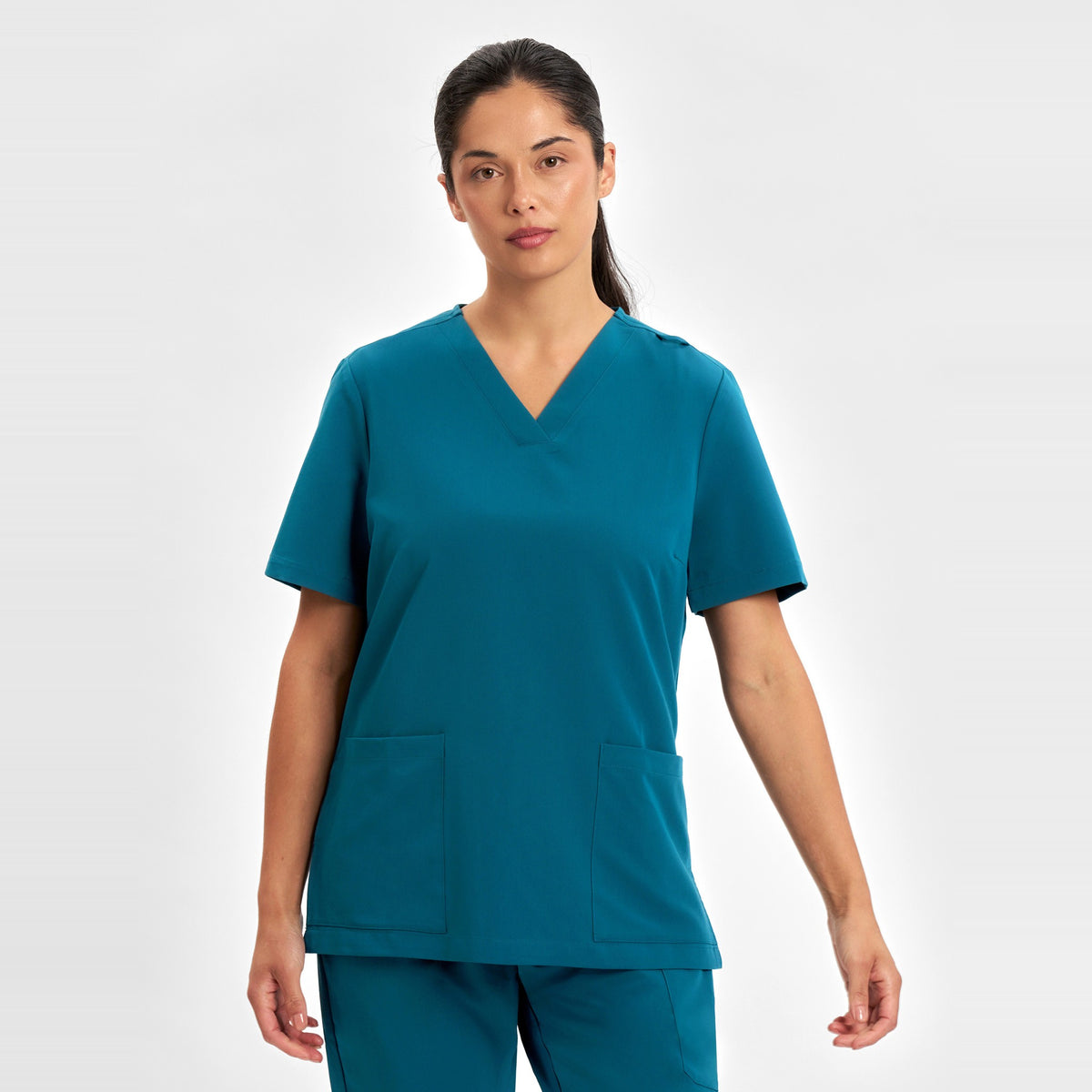 Inaura Pulse Womens V-Neck Scrub Top CU543LS in Caribbean Blue, worn by model