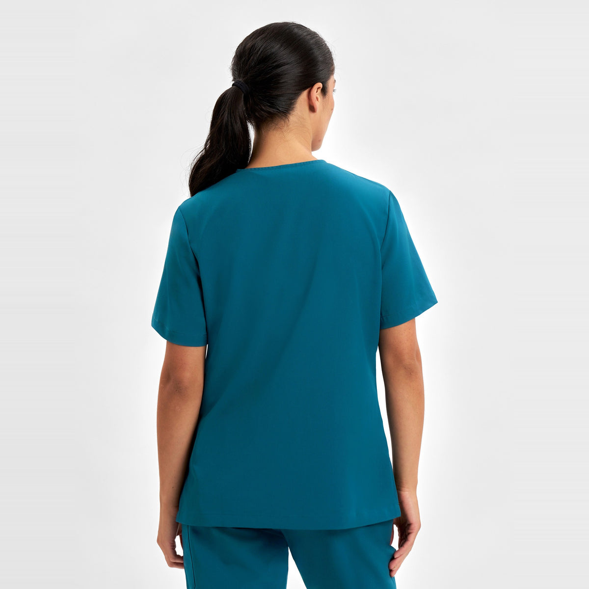 Inaura Pulse Womens V-Neck Scrub Top CU543LS in Caribbean Blue, worn by model, view 4