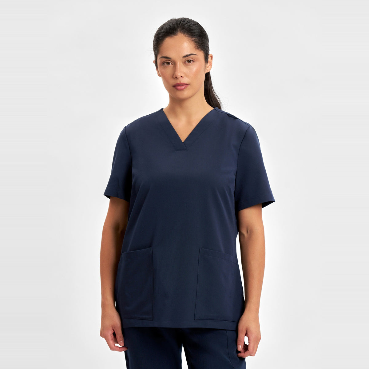 Inaura Pulse Womens V-Neck Scrub Top CU543LS in Midnight Navy, worn by model