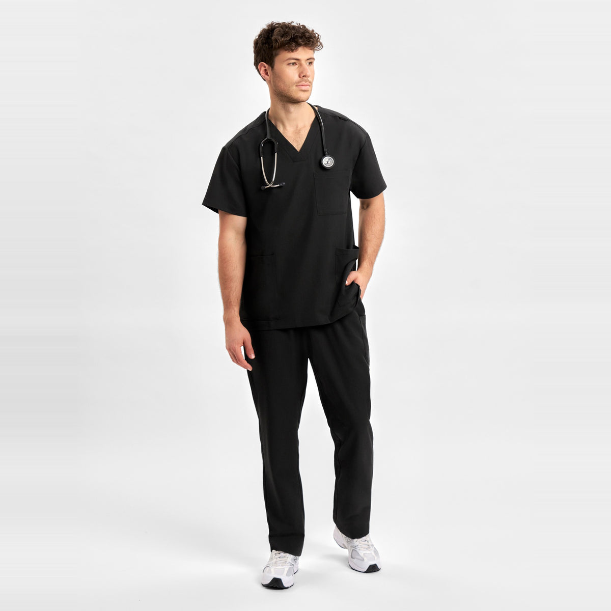 Inaura Pulse Unisex V-Neck Scrub Top CU544US in Black, worn by model, view 2
