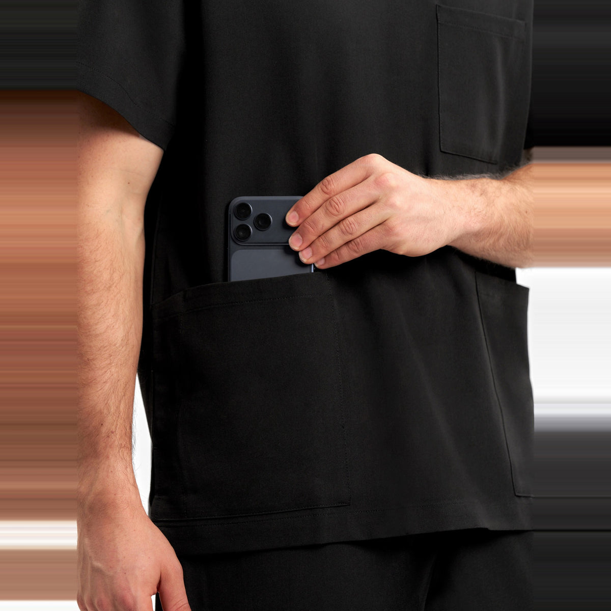 Inaura Pulse Unisex V-Neck Scrub Top CU544US in Black, worn by model, view 6